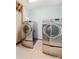 Laundry room featuring a modern washer and dryer on tile floors at 12002 Cobham Ct, Huntersville, NC 28078