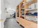 Walk-in closet featuring carpet and built-in shelves and dresser for maximum storage at 12002 Cobham Ct, Huntersville, NC 28078