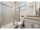 Bathroom featuring tiled shower with glass door and granite countertop sink at 12410 Franklin Park Ln, Huntersville, NC 28078