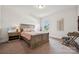 Bright bedroom with a wooden bed frame, neutral walls, and a view of the outside at 12410 Franklin Park Ln, Huntersville, NC 28078