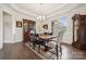 Formal dining room with elegant furnishings, chandelier, and hardwood floors at 12410 Franklin Park Ln, Huntersville, NC 28078