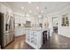 Spacious kitchen with stainless steel fridge, granite counters, central island and ample cabinetry at 12410 Franklin Park Ln, Huntersville, NC 28078