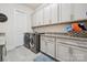 Functional laundry room with granite countertops, washer, dryer, and ample cabinet space at 12410 Franklin Park Ln, Huntersville, NC 28078
