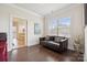 Comfortable living room with hardwood floors, a window with natural light, and access to bathroom at 12410 Franklin Park Ln, Huntersville, NC 28078