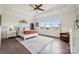 Spacious main bedroom with a tray ceiling, a ceiling fan, and a view of the neighborhood at 12410 Franklin Park Ln, Huntersville, NC 28078