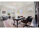 Bright home office with a large desk, cozy sitting area, and natural light at 12410 Franklin Park Ln, Huntersville, NC 28078