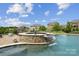 Beautiful in-ground pool featuring a rock waterfall, lovely patio, and views of neighboring homes and blue skies at 12410 Franklin Park Ln, Huntersville, NC 28078