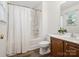 Charming bathroom with shower-tub, modern vanity, updated fixtures, and a window for natural light at 146 Rapids Rd, Fort Mill, SC 29715