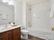 A well-lit bathroom features a single vanity, toilet, and tub with shower, all in a neutral color palette at 146 Rapids Rd, Fort Mill, SC 29715