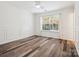 Bright bedroom with hardwood floors, fresh paint, molding, and a large window offering natural light at 146 Rapids Rd, Fort Mill, SC 29715