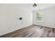 Bedroom with hardwood floors, fresh paint, and a bright window overlooking the yard at 146 Rapids Rd, Fort Mill, SC 29715