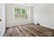 Bright bedroom features a large window with shutters and wood-look flooring at 146 Rapids Rd, Fort Mill, SC 29715