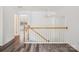 Hallway featuring hardwood floors, fresh paint, updated banister, and abundant natural light at 146 Rapids Rd, Fort Mill, SC 29715