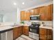 Well-equipped kitchen featuring stainless steel appliances and warm wood cabinets at 146 Rapids Rd, Fort Mill, SC 29715