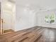 Open living room featuring hardwood floors, fresh paint, modern lighting, and natural light at 146 Rapids Rd, Fort Mill, SC 29715