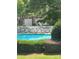 Community swimming pool surrounded by lounge chairs, greenery, and nearby garage units for residents' convenience at 146 Rapids Rd, Fort Mill, SC 29715