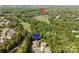 Aerial view of neighborhood near country club and golf course surrounded by mature trees at 15103 Cimarron Hills Ln, Charlotte, NC 28278