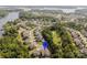 Community aerial view showcasing homes nestled amongst lush greenery, a nearby lake, and mature trees at 15103 Cimarron Hills Ln, Charlotte, NC 28278