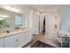 Bright bathroom with granite countertops, a large mirror, and a walk-in glass shower at 15103 Cimarron Hills Ln, Charlotte, NC 28278