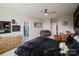 Spacious bedroom featuring a ceiling fan, a cozy seating area, and an open closet for ample storage at 15103 Cimarron Hills Ln, Charlotte, NC 28278