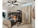 Cozy bedroom featuring a bunk bed, neutral decor, and a ceiling fan for a relaxing and comfortable space at 15103 Cimarron Hills Ln, Charlotte, NC 28278