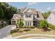Charming home with well-manicured lawn and landscaping, featuring a mix of trees and shrubs at 15103 Cimarron Hills Ln, Charlotte, NC 28278