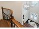 Bright foyer featuring hardwood flooring, a modern chandelier, and a staircase with wood and black iron accents at 15103 Cimarron Hills Ln, Charlotte, NC 28278