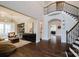 Grand foyer with hardwood floors, curved staircase, and sophisticated decor, showcasing an open floor plan at 15103 Cimarron Hills Ln, Charlotte, NC 28278