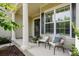 Cozy front porch with seating area featuring stylish chairs, pillows, and decorative plants at 15103 Cimarron Hills Ln, Charlotte, NC 28278