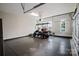 Epoxy-coated garage featuring a golf cart and abundant natural light at 15103 Cimarron Hills Ln, Charlotte, NC 28278