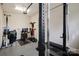 Home gym featuring ample workout equipment and a bright skylight at 15103 Cimarron Hills Ln, Charlotte, NC 28278