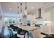 Open kitchen with white cabinetry, granite countertops, modern lighting, and seamless flow to dining and living areas at 15103 Cimarron Hills Ln, Charlotte, NC 28278