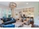 Open concept living room showcases a modern kitchen with breakfast bar seating and stylish pendant lighting at 15103 Cimarron Hills Ln, Charlotte, NC 28278