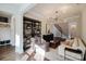 Inviting living room with hardwood floors, comfortable seating, a statement bookshelf, and a sophisticated ambiance at 15103 Cimarron Hills Ln, Charlotte, NC 28278