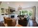 Bright living room features a stone fireplace, custom built-ins, and large windows overlooking the backyard at 15103 Cimarron Hills Ln, Charlotte, NC 28278