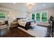 Serene main bedroom suite with elegant chandelier, large windows, and plush carpeting for a cozy retreat at 15103 Cimarron Hills Ln, Charlotte, NC 28278