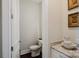 Elegant powder room featuring granite counters, hardwood flooring, and charming decor in neutral tones at 15103 Cimarron Hills Ln, Charlotte, NC 28278