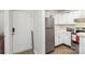 Open-concept entryway and kitchen equipped with stainless steel appliances and white cabinetry at 1602 Eagles Pl # J103, Rock Hill, SC 29732
