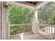 Exterior balcony with wood flooring, white railings, and view of lush greenery at 16344 Redstone Mountain Ln, Charlotte, NC 28277