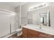 Neat bathroom featuring a glass shower and a wood-look vanity at 16344 Redstone Mountain Ln, Charlotte, NC 28277