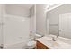 Bright bathroom featuring a tiled shower-tub combo and wood-look vanity at 16344 Redstone Mountain Ln, Charlotte, NC 28277