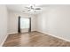 Bright bedroom featuring wood-look flooring, neutral walls, and window with blinds at 16344 Redstone Mountain Ln, Charlotte, NC 28277