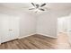 Well-lit bedroom featuring a ceiling fan, sleek floors, and a double-door closet at 16344 Redstone Mountain Ln, Charlotte, NC 28277