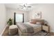 Well-lit bedroom showcasing a ceiling fan, a bed and an ottoman at 16344 Redstone Mountain Ln, Charlotte, NC 28277