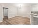 Clean dining room area with a modern light fixture and wood-look floors at 16344 Redstone Mountain Ln, Charlotte, NC 28277