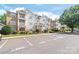 Apartment complex featuring well-manicured landscaping and ample parking at 16344 Redstone Mountain Ln, Charlotte, NC 28277