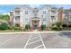 Well-maintained condo building with multiple units, balconies, parking, and landscaped grounds at 16344 Redstone Mountain Ln, Charlotte, NC 28277
