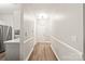 Inviting hallway with sleek floors leading to the kitchen and the front door at 16344 Redstone Mountain Ln, Charlotte, NC 28277