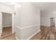Bright hallway showcasing sleek floors, fresh paint, and modern trim details at 16344 Redstone Mountain Ln, Charlotte, NC 28277