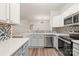 Stylish kitchen with stainless steel appliances and mosaic tile backsplash, showcasing open concept layout at 16344 Redstone Mountain Ln, Charlotte, NC 28277